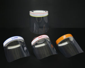 Sample face shields with company logos.